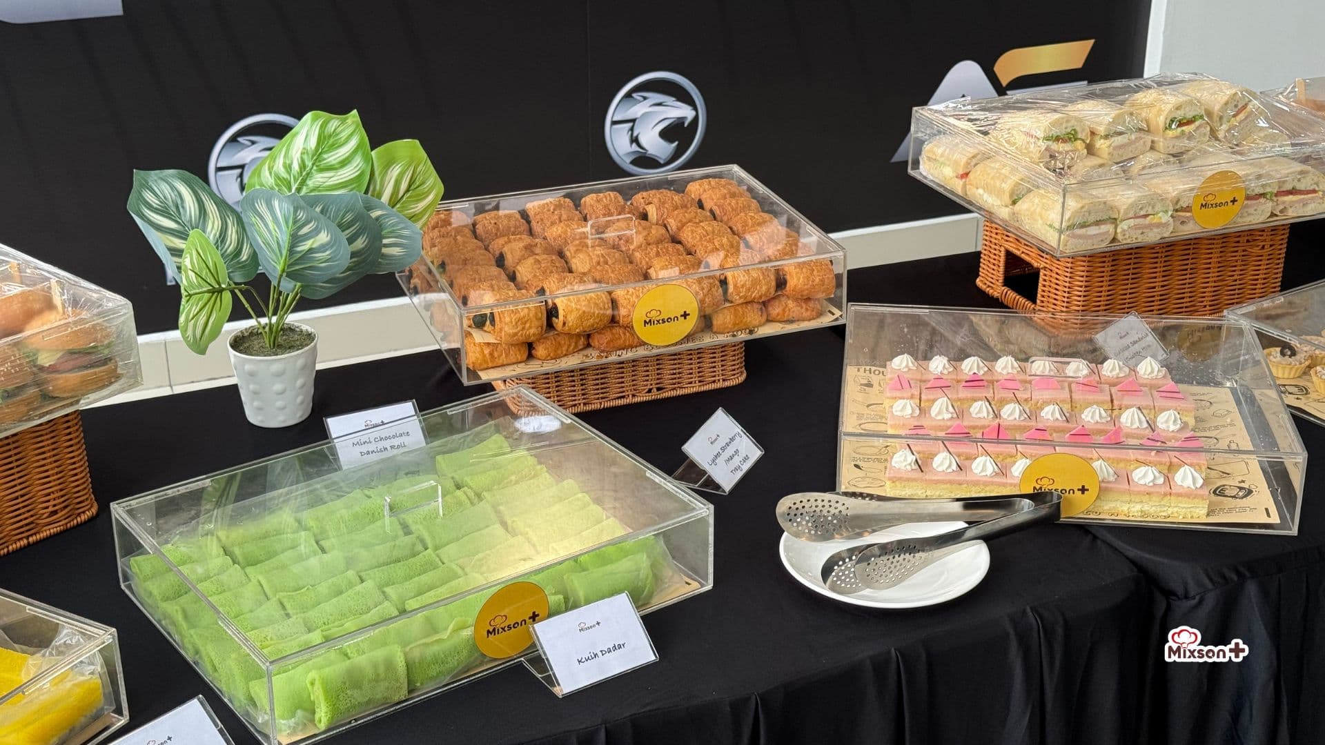Dessert and kuih table at a Proton dealership event