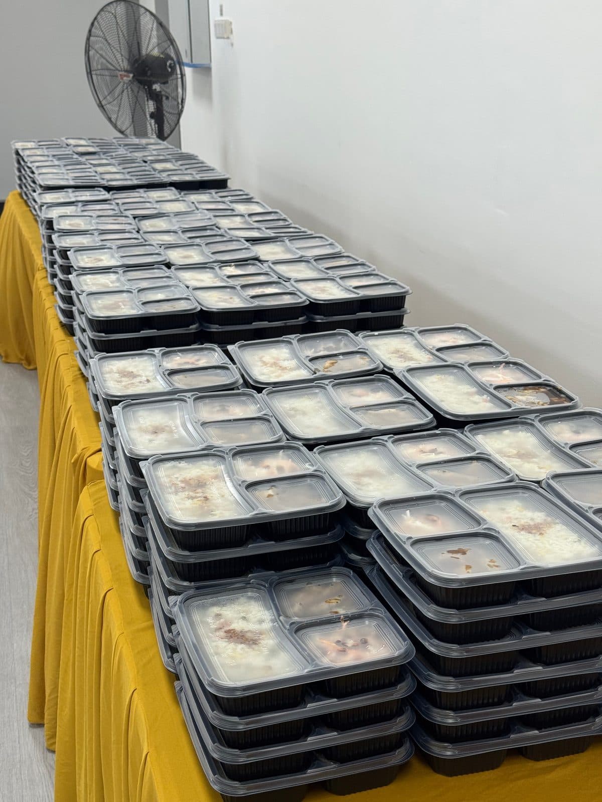 Sealed bento boxes stacked for a daily meal delivery