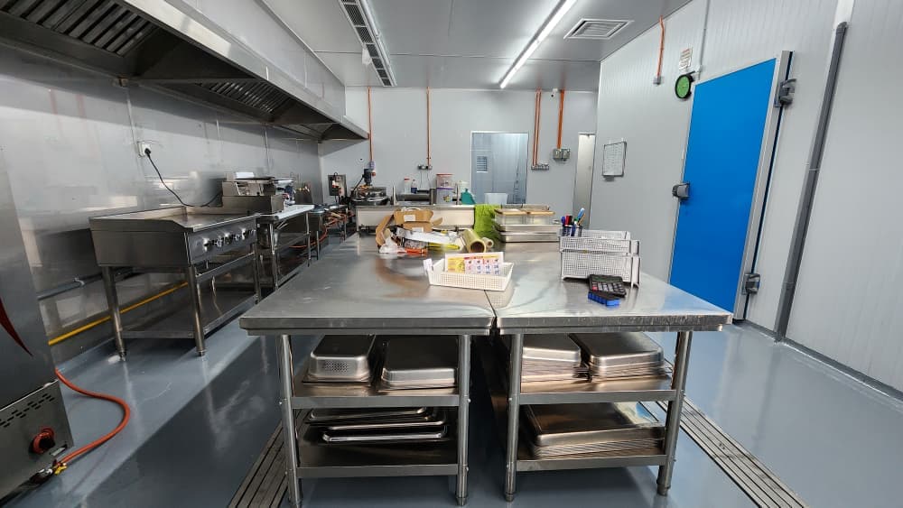 Inside the Mixson Plus central kitchen — modern stainless steel equipment