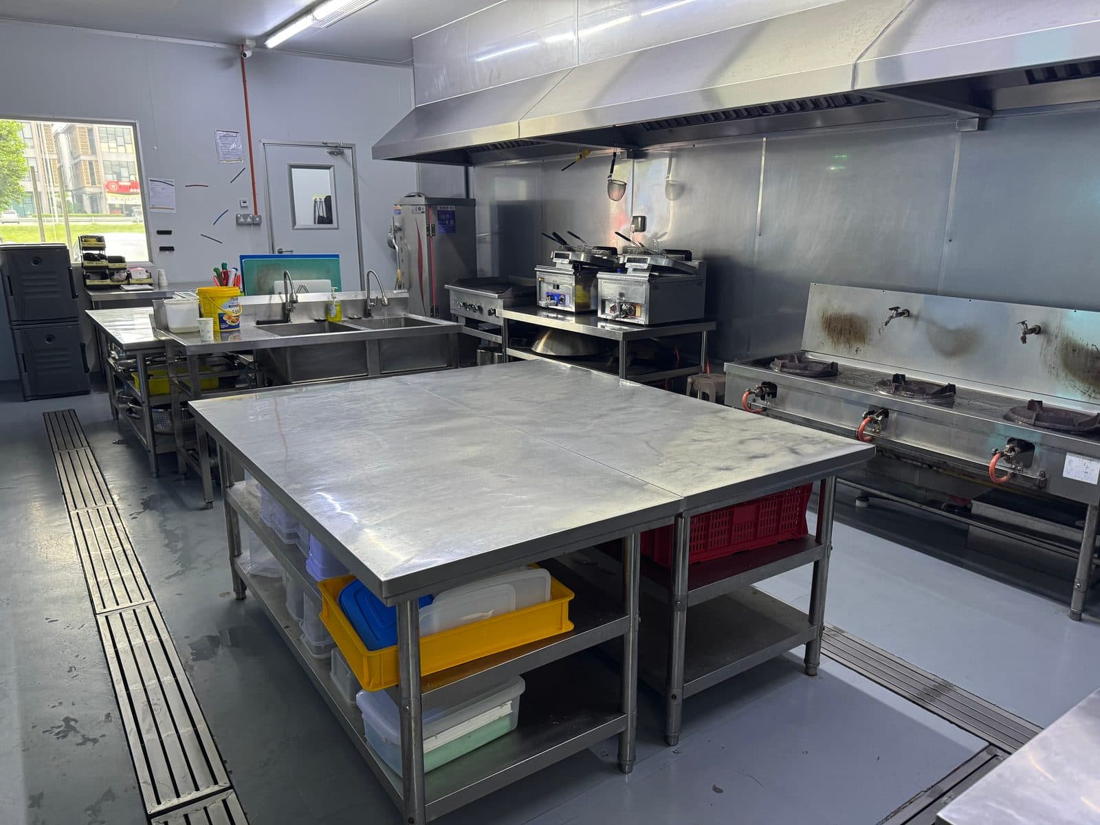 Cooking line with wok range and fryers at our Senai central kitchen